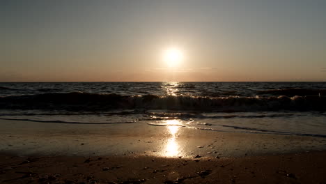 Sunset-Over-Dark-Bay-with-Waves-in-Slow-Motion