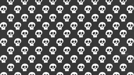 Animación-De-Fondo-De-Halloween-Pequeñas-Calaveras-Blancas-Moviéndose-Hacia-Arriba-Sobre-Fondo-Gris-Con-Grano