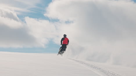 pilot-driving-snowmobile-in-white-snow,-splashing-powder-away