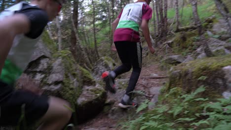 Two-Sport-Athlete´s-Running-up-steep-hill-mossy-forest,-Norway