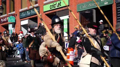 British-Pilgrims-with-muskets-marching-down-the-street-with-old-English-flag-during-Thanksgiving-Parade-2019-in-Plymouth-Massachusetts