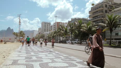 People-walking,-running,-cycling-at-Calçadão-at-Ipanema