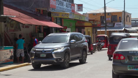 Taxis-drive-up-and-down-a-busy-village-street