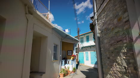 A-view-of-traditional-houses-with-blue-accents-under-a-bright-sky-in-Lefkara,-Cyprus