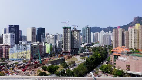 Aerial-view-of-Hong-Kong-residential-buildings-with-Lion-rock-mountains-in-the-horizon