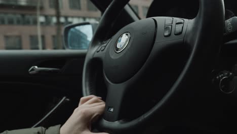 Guy-in-green-rainjacket-is-driving-a-BMW,-Slow-Motion