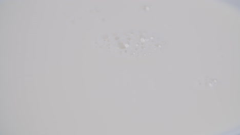 Foamy-milk-bubbles-popping-close-up