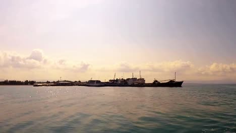 A-view-of-the-municipal-port-of-Hilongos,-Leyte-from-the-vantage-point-of-a-vessel-that-has-undocked-and-turned-prior-to-entering-cruising-speed