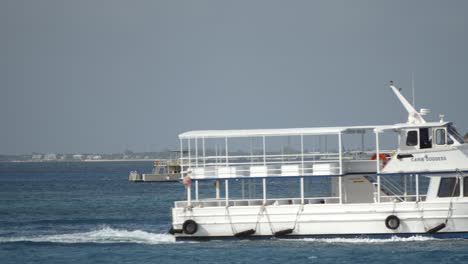 An-empty-cruise-ship-ferry-boat-travels-through-the-frame-to-go-and-pick-up-passengers