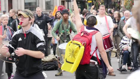 Slow-motion-clip-of-a-woman-leading-street-performers-during-the-extinction-rebellion-protests-in-London