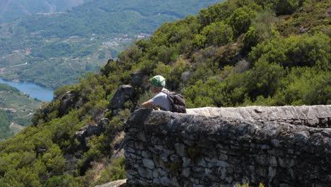 Keen-tourist-looking-out-over-the-Ribeira-Sacra-in-Spain,-pan-left