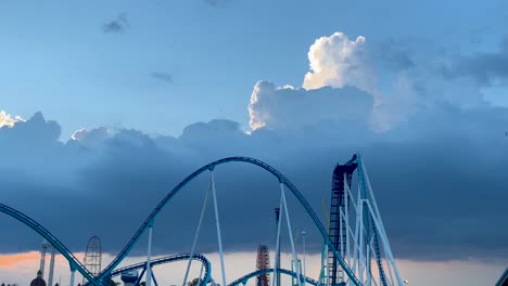 4K-Dramatic-landscape-view-of-Cedar-point-amusement-park-from-parking-lot--Gatekeeper-Ride-roller-coaster-with-a-blue-sky-and-clouds-in-the-background