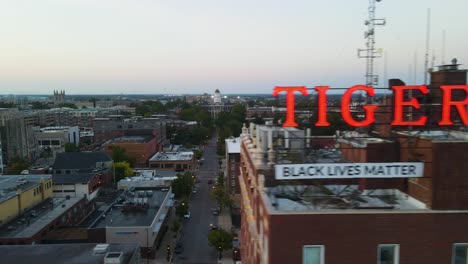 Social-Justice-Concept---Black-Lives-Matter-Slogan-on-City-Building,-Aerial-Drone-Reveal