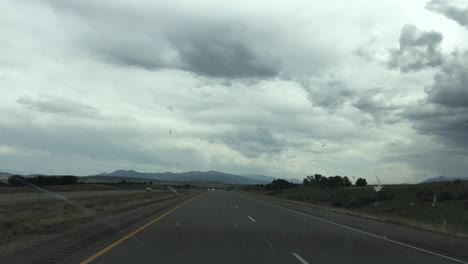 Point-of-view-of-the-wind-shield-as-a-car-drives-on-the-highway