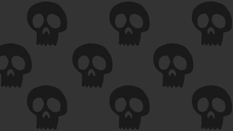 Halloween-Background-animation-large-neutral-black-skulls-moving-to-the-left-over-gray-background