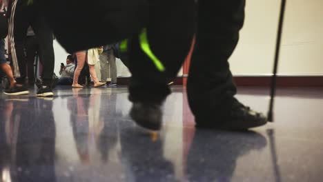 Frog-perspective-of-tourists-crossing-airport-corridor-in-California