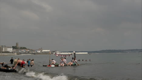 Local-business-team-runner-up-at-the-Newlyn-raft-race-charity-fun-outdoors-event,-Cornwall