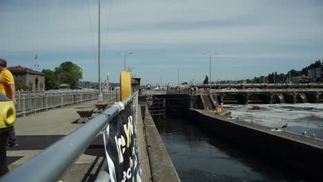Time-Lapse-of-boats-exiting-and-entering-the-Ballard-Locks,-Lock-empties-and-several-boats-exit-and-one-enters
