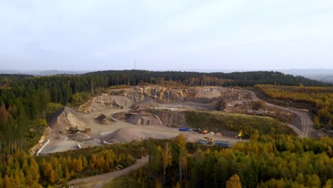 Aerial-view-of-quarry-in-the-middle-of-forest-with-autumn-colours