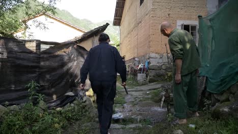 Woman-walking-through-her-village-to-go-gardening