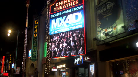 Walk-of-Fame-shop-facades-by-night,-Hollywood-Boulevard-,-Los-Angeles,-California,-US