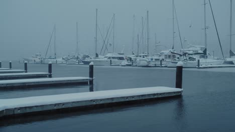 An-early-winter-morning-on-the-Poulsbo-Harbor-during-a-rare-Seattle-snow-storm,-looking-out-at-the-boats