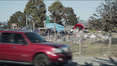 Wide-shot-of-a-homeless-camp-along-the-freeway-in-Berkeley,-California