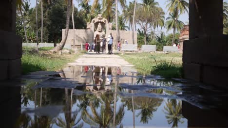 Vijaya-Vittala-Temple,-Hampi-In-Karnataka,-India---Group-Of-Tourists-Moving-Around-Outside-The-Temple-Where-The-Majestic-Statue-Of-Lakshmi-Narasimha