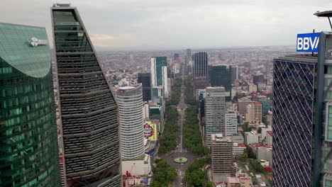 Breathtaking-flight-above-Paseo-de-la-reforma-financial-district,-avenue,-city-skyscrapers-in-Latam-torre-mayor,-reforma,-BBVA,-chapultepec-uno,-towers-towards-angel-of-independence-monument,-aerial