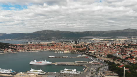 Slide-shot-to-the-left-of-a-big-Croatian-harbor-City-with-ferrys