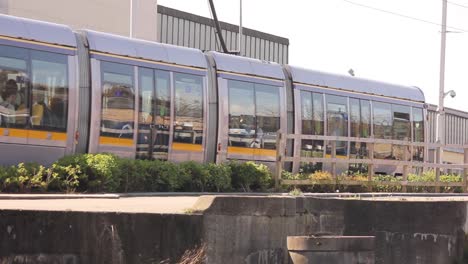 Dublin-public-transportation-luas-tram-passes-by-the-canal-in-the-city