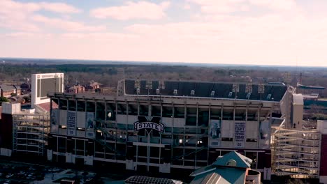 Aerial-drone-flight-towards-Davis-Wade-Stadium,-football-team-of-Mississippi-State-Bulldogs-during-sunset