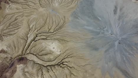 Wonderful-drone-shot,-over-the-dry,-desert-lands-of-a-mud-volcano-with-fissures-in-the-ground