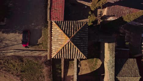 A-historic-tiled-roof-in-marganell,-barcelona,-spain-during-the-day,-aerial-view