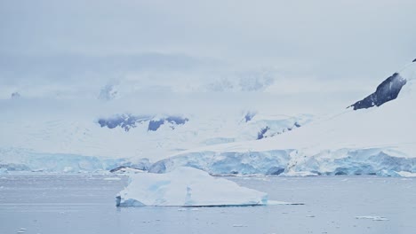 Icebergs-and-Mountains-Scenery-with-Glacier-and-Ice-in-Antarctica-Landscape-Scene,-Global-Warming-and-Climate-Change-in-Coastal-Ocean-and-Sea-Water-on-Coast-of-Antarctic-Peninsula-in-Winter