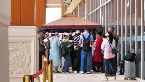 People-queuing-outside-Boten-Railway-Station-in-Laos,-illustrating-the-concept-of-efficient-travel-and-cross-border-transportation,-connectivity-and-movement-within-Southeast-Asia