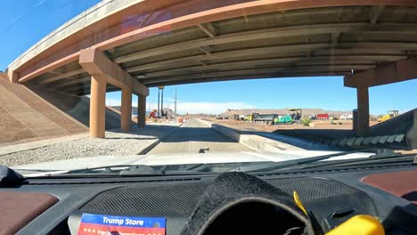 POV---Driving-under-Interstate-10,-through-road-construction-and-past-a-Love's-fuel-truck-stop-on-a-bright-sunny-day