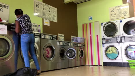 African-American-woman-doing-laundry-in-a-laundromat