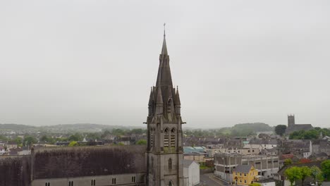 Saint-Michael's-Church-in-Ballinasloe-Galway,-wide-angle-aerial-orbit-overview-on-misty-day