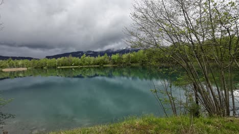 Fishing-Lake-in-Europe-Austria-surrounded-by-Forest-and-Mountains