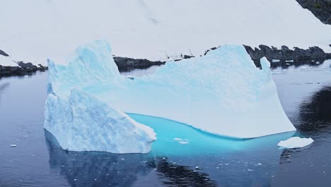 Big-Iceberg-in-Antarctica-Winter-Scenery,-Amazing-Shape-Ice-Formation-of-Massive-Large-Enormous-Blue-Icebergs-in-Antarctic-Peninsula-Landscape-Seascape-with-Ocean-Sea-Water