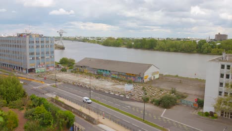 Profile-view-of-industrial-area-and-Loire-river-in-the-background-during-daytime-in-Nantes,-France