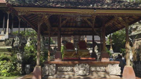 Trono-Del-Rey-De-Ubud-Y-Turistas-Se-Reúnen-De-Gira-En-El-Palacio-De-Ubud,-Oficialmente-Puri-Saren-Agung---Complejo-Histórico-De-Edificios-De-La-Familia-Real-En-Ubud,-Regencia-Gianyar-De-Bali,-Indonesia