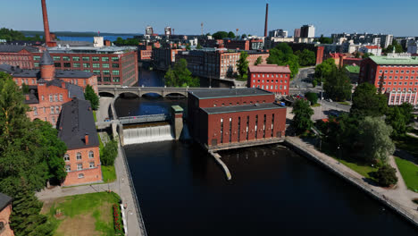 Aerial-view-toward-the-Tammerkoski-dam,-sunny,-summer-day-in-Tampere,-Finland