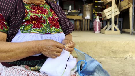 Mexican-craftswoman-sitting-knitting-in-Michoacan-in-white-cloth