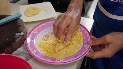 Coating-Chicken-Strip-With-Panko-Bread-Crumbs-Before-Frying