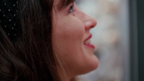 Young-beautiful-woman-with-dark-hair-looking-amazed-above-with-a-big-smile-on-her-face-during-a-night-in-slow-motion