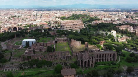 Backward-Drone-Shot-flying-away-from-Palatine-Hill,-Ancient-Roman-Colosseum