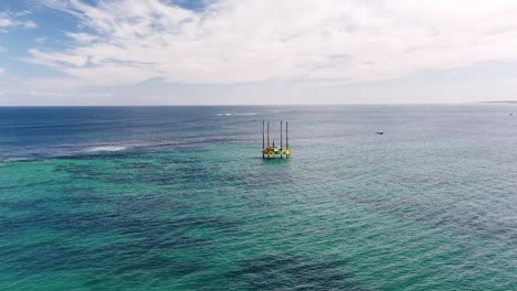 High-aerial-view-towards-Geolocigal-drilling-platform-in-shallow-water-near-Alkimos-Reef,-Perth