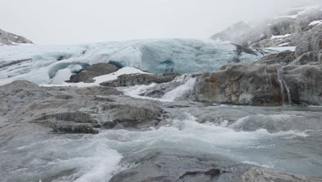 Water-flowing-down-from-a-melting-Brewster-Glacier-at-Brewster-Track-in-Mount-Aspiring-National-Park,-New-Zealand